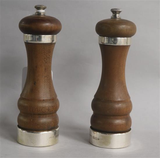 A pair of 1960s silver mounted turned wooden salt and pepper mills, 15.1cm.